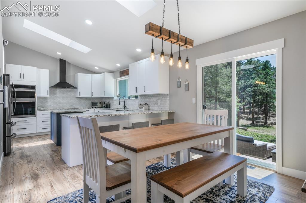 Image 18 of 50: Dining area with access to back patio