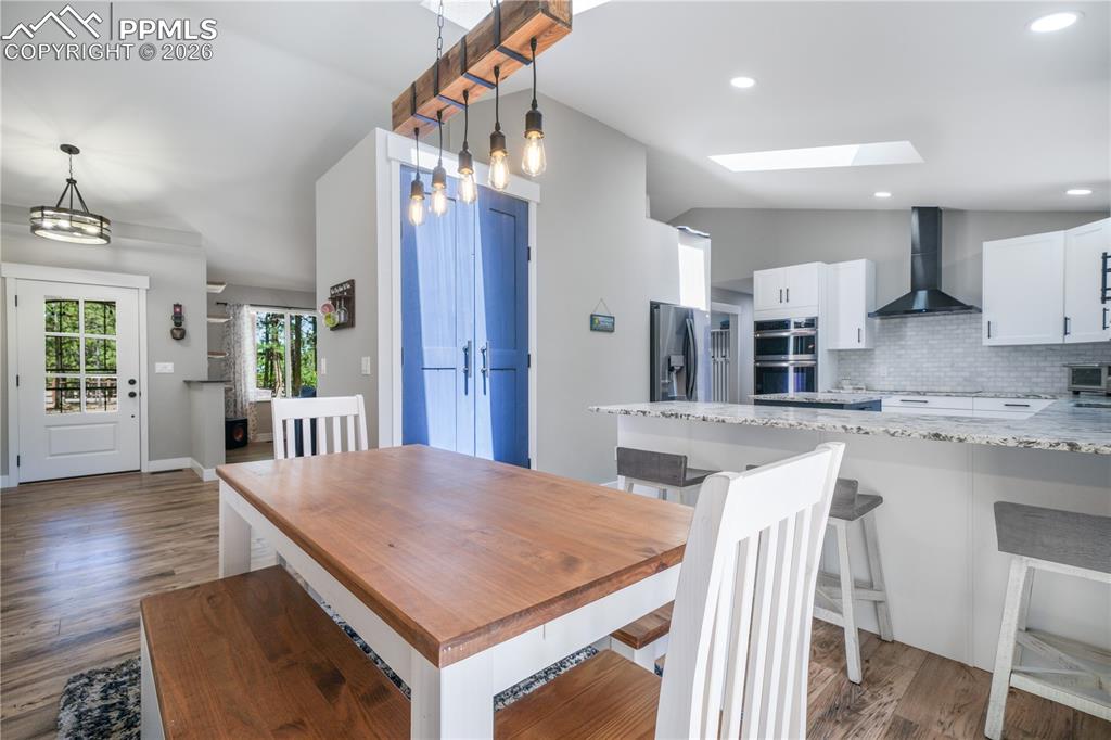 Image 19 of 50: Dining area with access to back patio