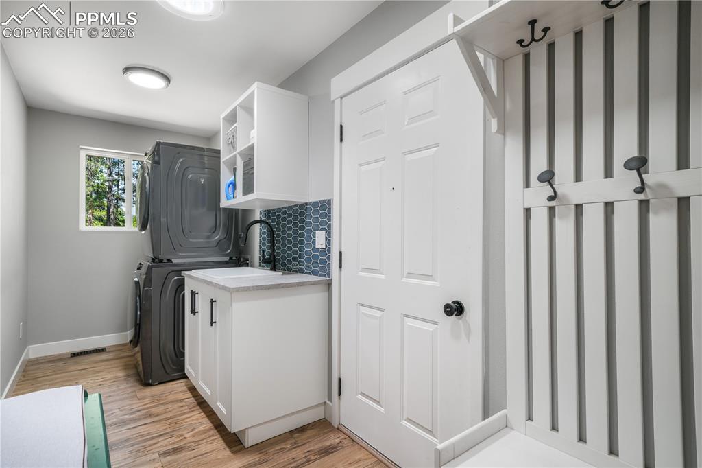 Image 30 of 50: Main level laundry with mud room, window and sink