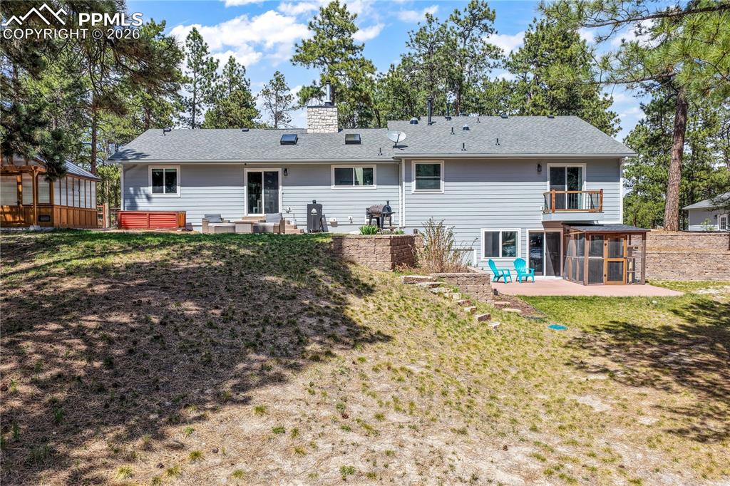 Image 36 of 50: Back of home, views of patio
