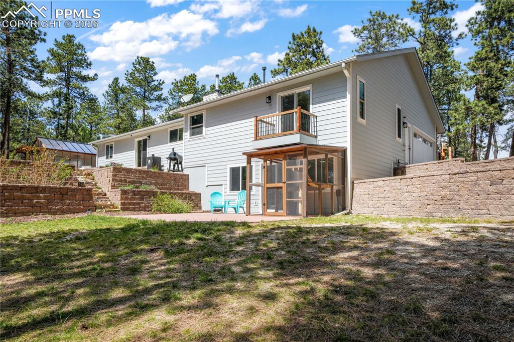Image 37 of 50: Back of home, views of patio