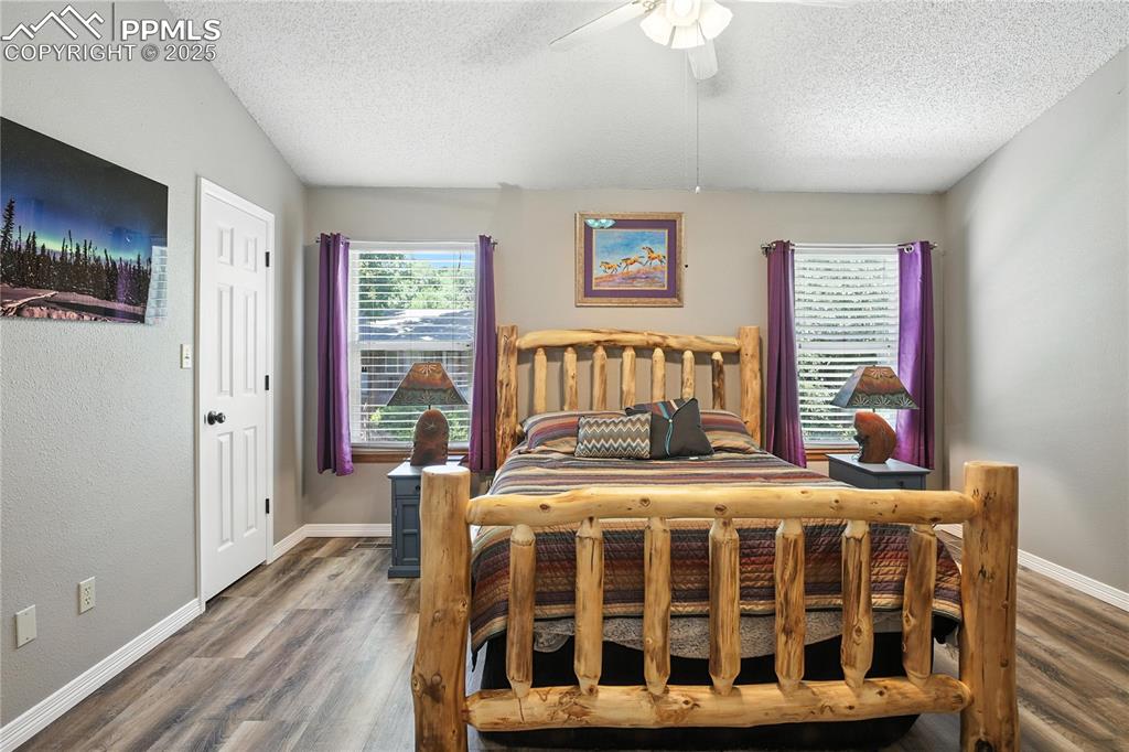 Image 15 of 25: Primary bedroom with vaulted ceilings complete with it