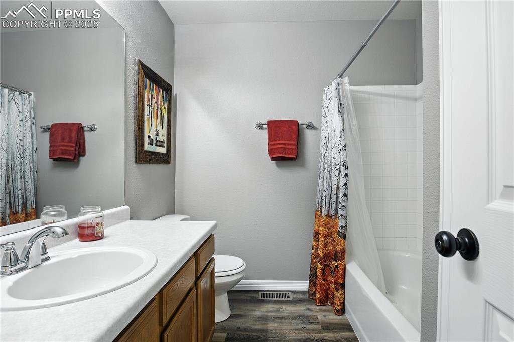 Image 17 of 25: Bathroom featuring vanity and bathing tub / shower combination