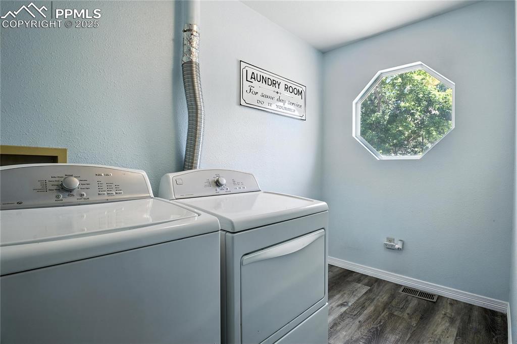 Image 21 of 25: Laundry room featuring washing machine, clothes dryer and window