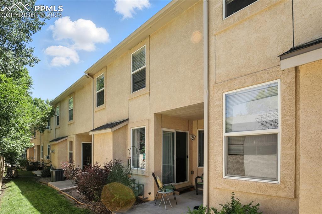 Image 25 of 25: Back of property featuring stucco siding and a patio area