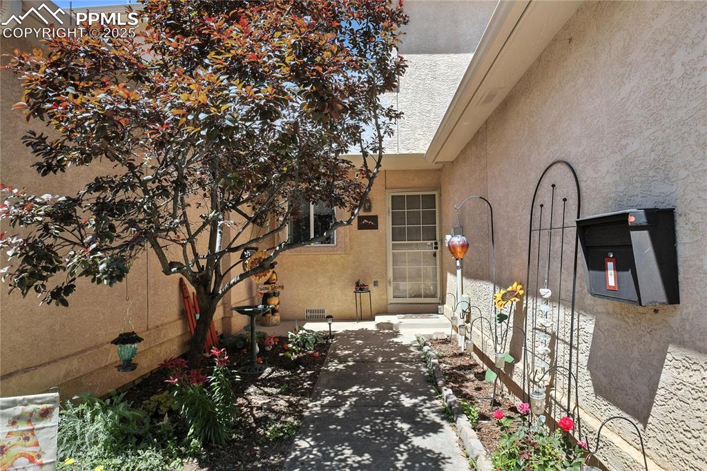 Image 3 of 25: Entrance to property featuring stucco siding