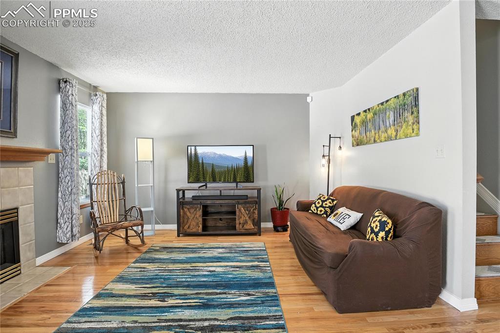 Image 5 of 25: Freshly painted walls, newer wood laminate flooring, and fireplace. 