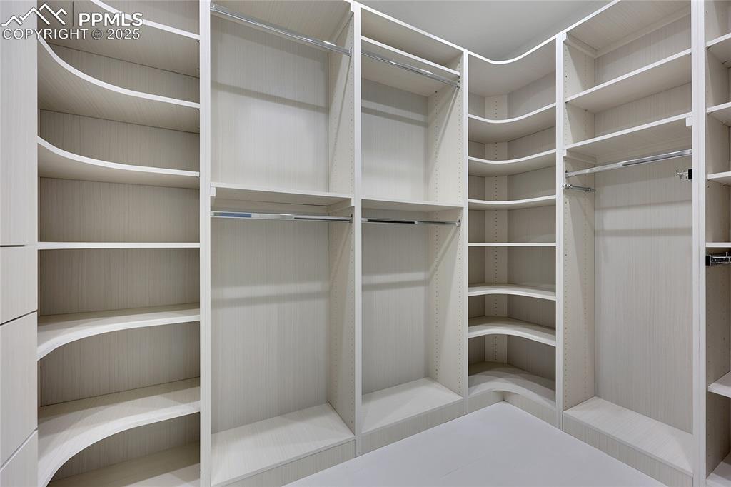 Image 29 of 48: Large walk in closets with custom shelving