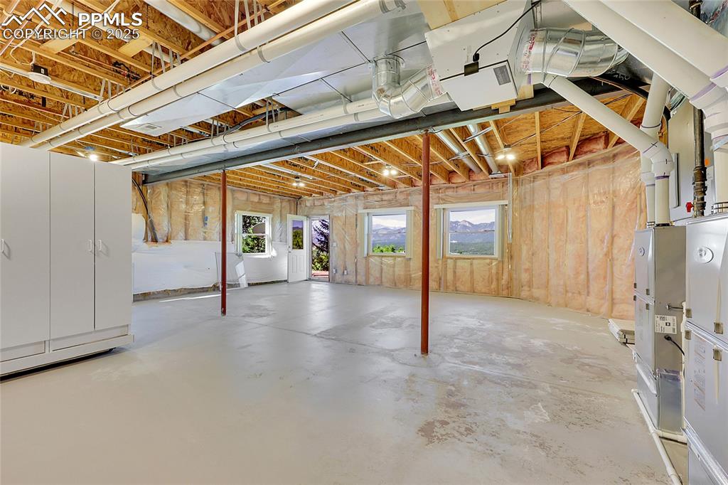 Image 40 of 48: Unfinished Flex Space/Storage area w/rotating storage-door to back yard