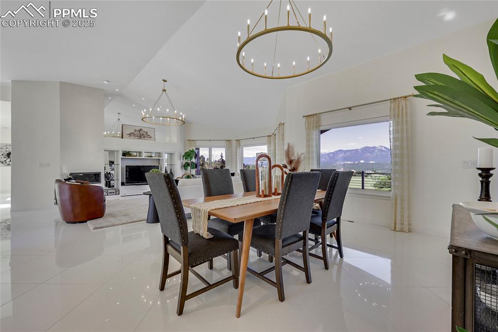 Image 9 of 48: Dining space featuring a chandelier, light tile patterned flooring, plenty