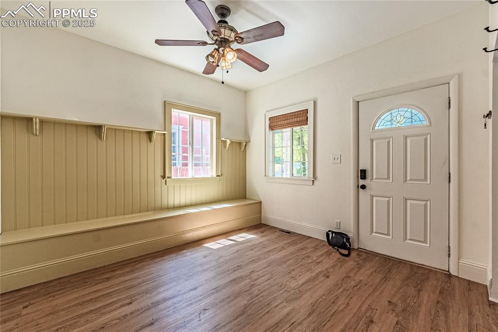 Image 10 of 36: Entrance foyer with wood finished floors and a ceiling fan