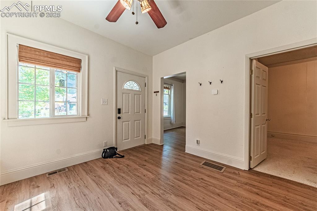 Image 11 of 36: Entryway with light wood-type flooring and ceiling fan