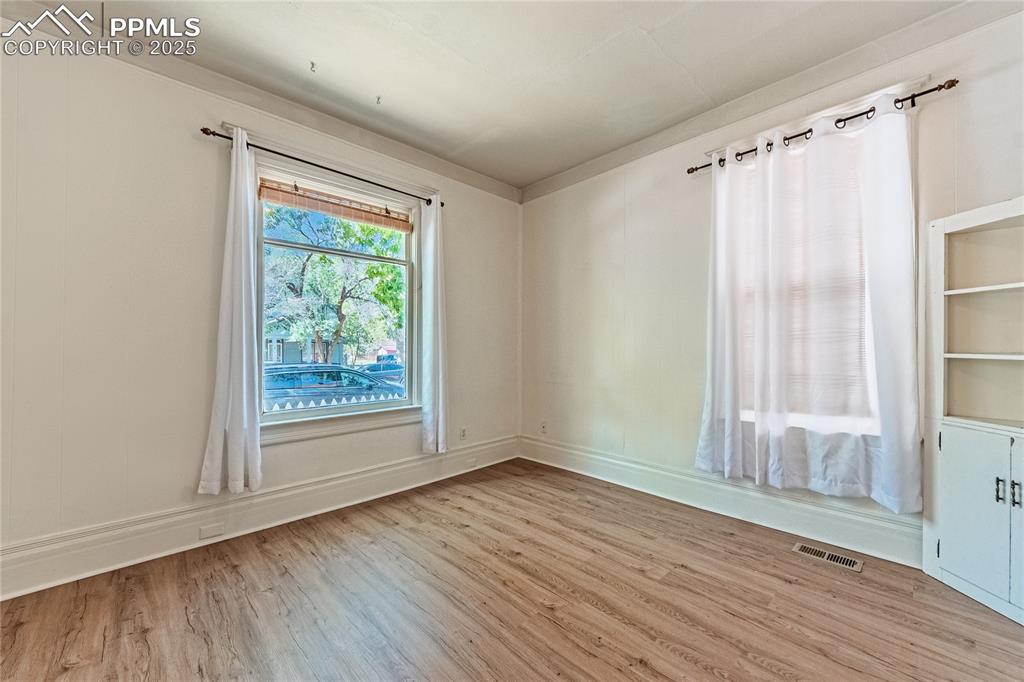 Image 12 of 36: Unfurnished room featuring wood finished floors