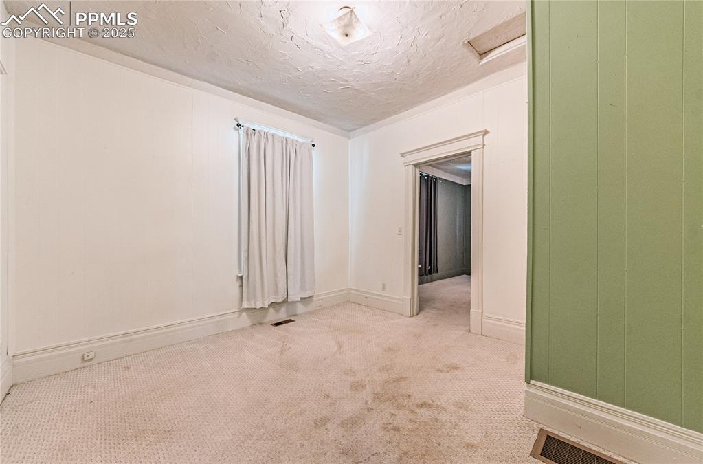 Image 14 of 36: Unfurnished room featuring a textured ceiling, carpet floors, and attic acc