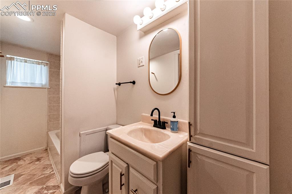 Image 20 of 36: Full bath with vanity and tub / shower combination