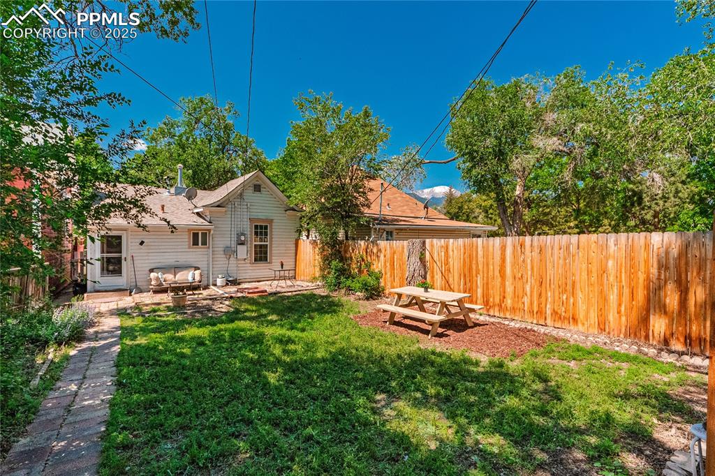 Image 30 of 36: Fenced backyard featuring a patio