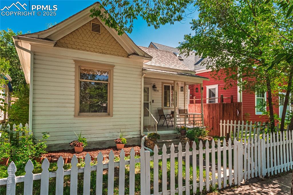Image 32 of 36: View of front of property with covered porch and a shingled roof