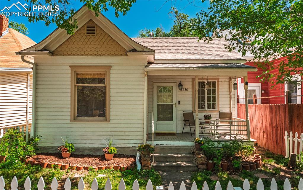 Image 33 of 36: View of front of home featuring covered porch