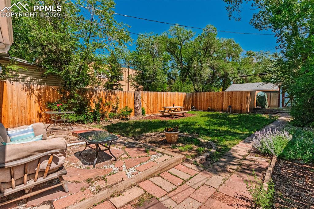 Image 4 of 36: Fenced backyard featuring a patio
