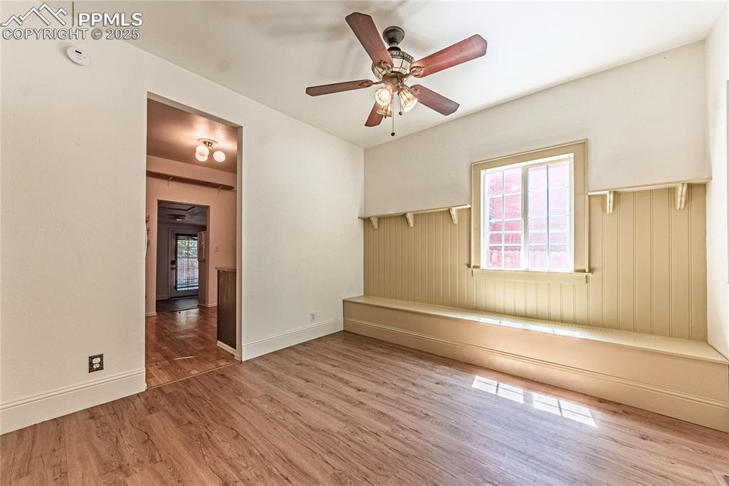 Image 9 of 36: Empty room with wood finished floors and ceiling fan