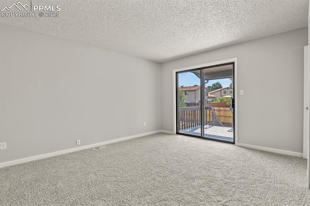 Image 18 of 39: Carpeted spare room with a textured ceiling