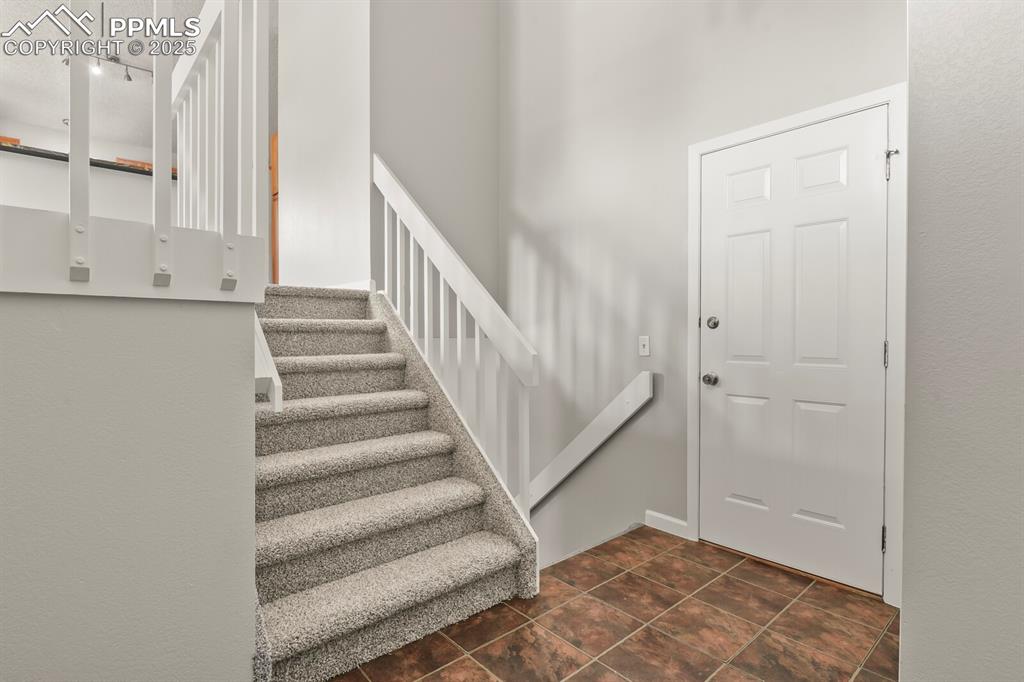 Image 6 of 39: Entryway with rail lighting and stairs