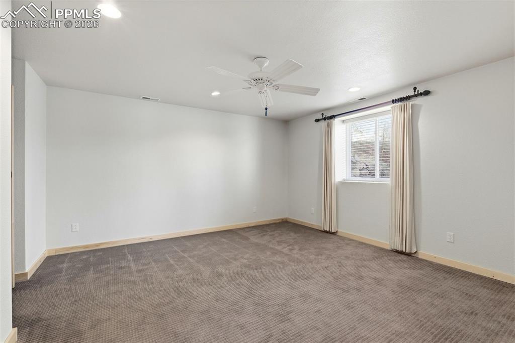Image 27 of 50: Spare room with dark colored carpet, recessed lighting, and ceiling fan