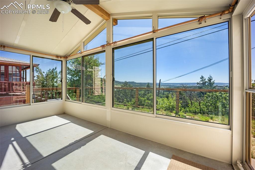 Image 37 of 50: Unfurnished sunroom with a ceiling fan and plenty of natural light