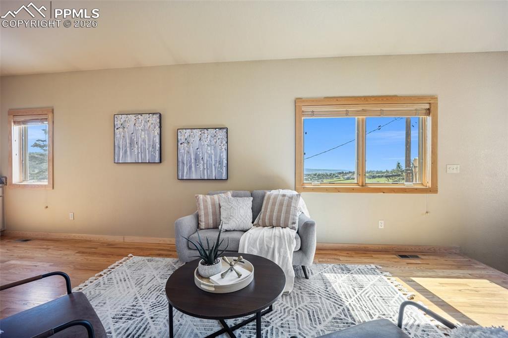 Image 7 of 50: Living area featuring light wood-style flooring