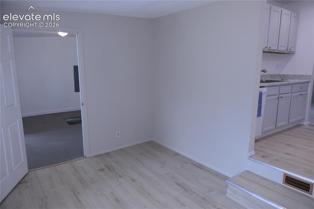 Image 12 of 39: Dining room looking towards kitchen and laundry