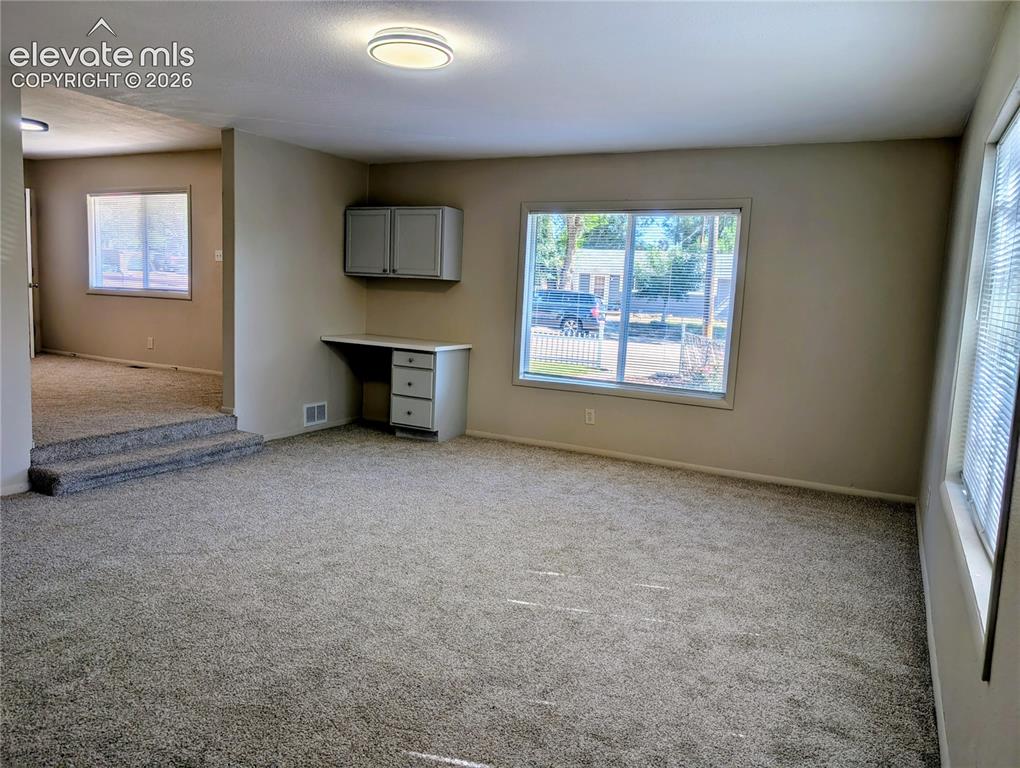 Image 15 of 39: Family room looking towards living room and front entry