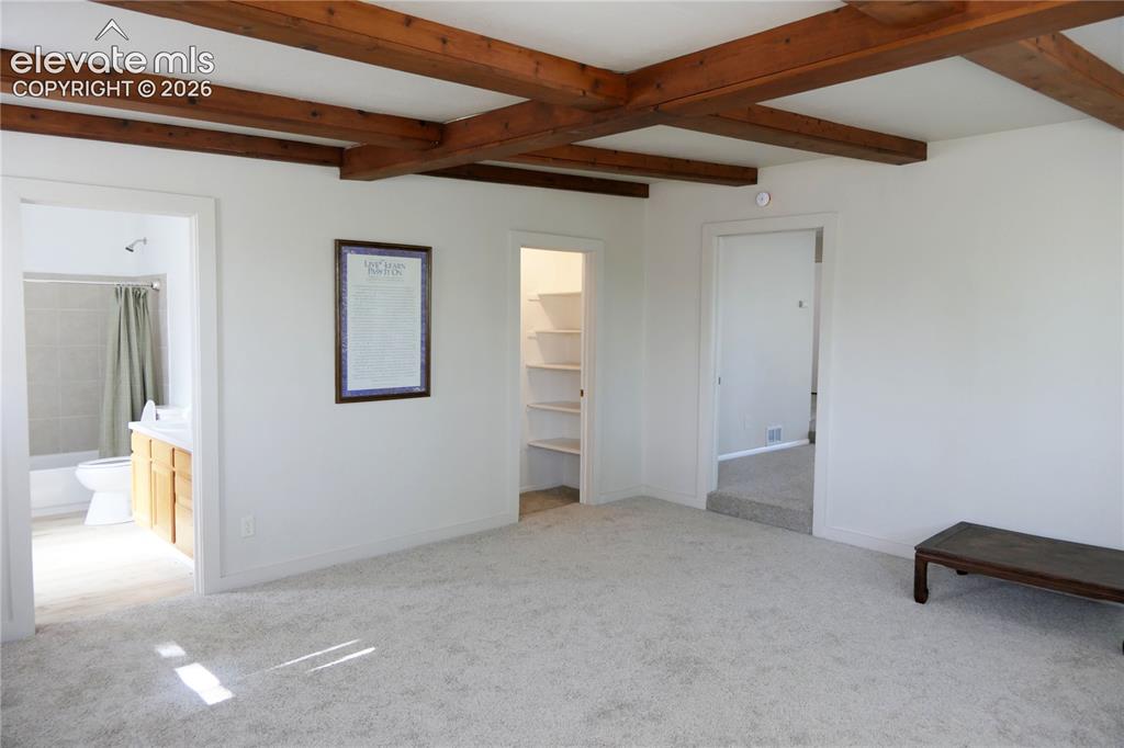 Image 18 of 39: Primary bedroom looking towards primary bath and walk-in closet