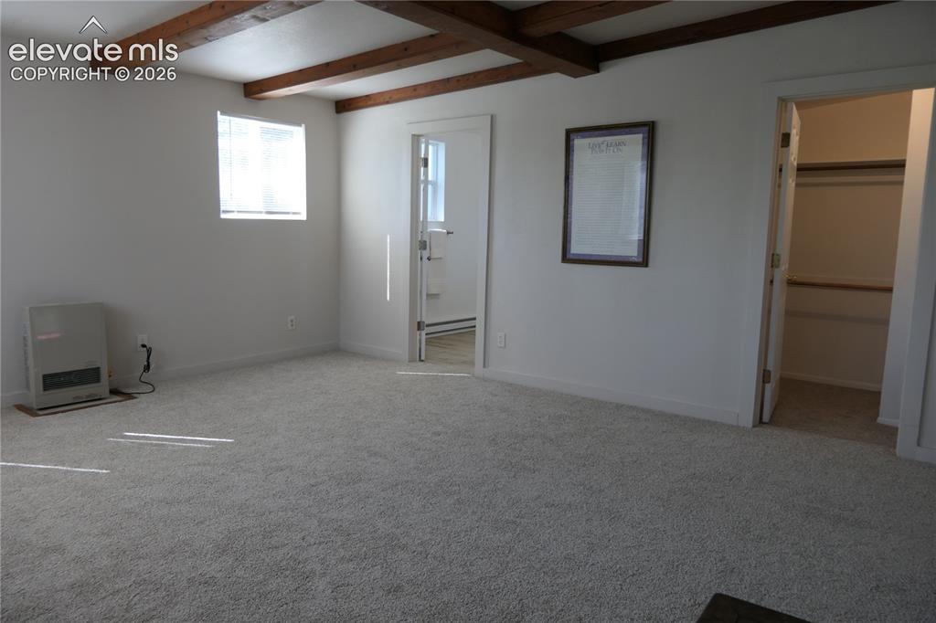 Image 19 of 39: Primary bedroom looking towards primary bath and walk-in closet