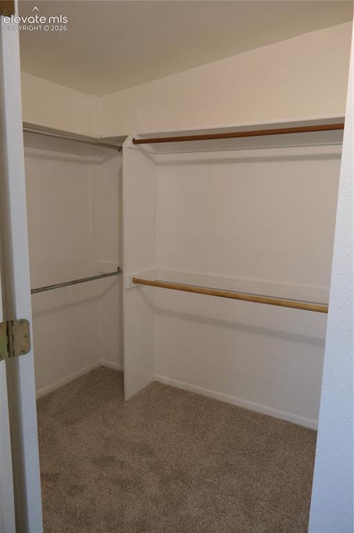 Image 20 of 39: Walk-in closet in primary bedroom