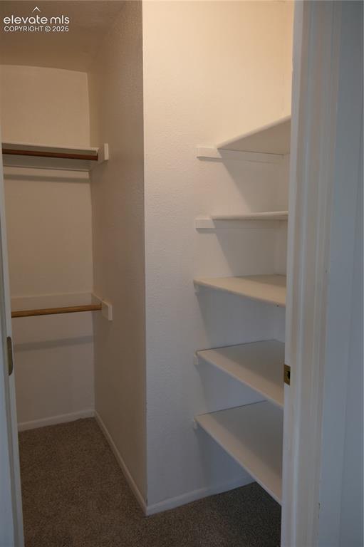 Image 21 of 39: Walk-in closet in primary bedroom