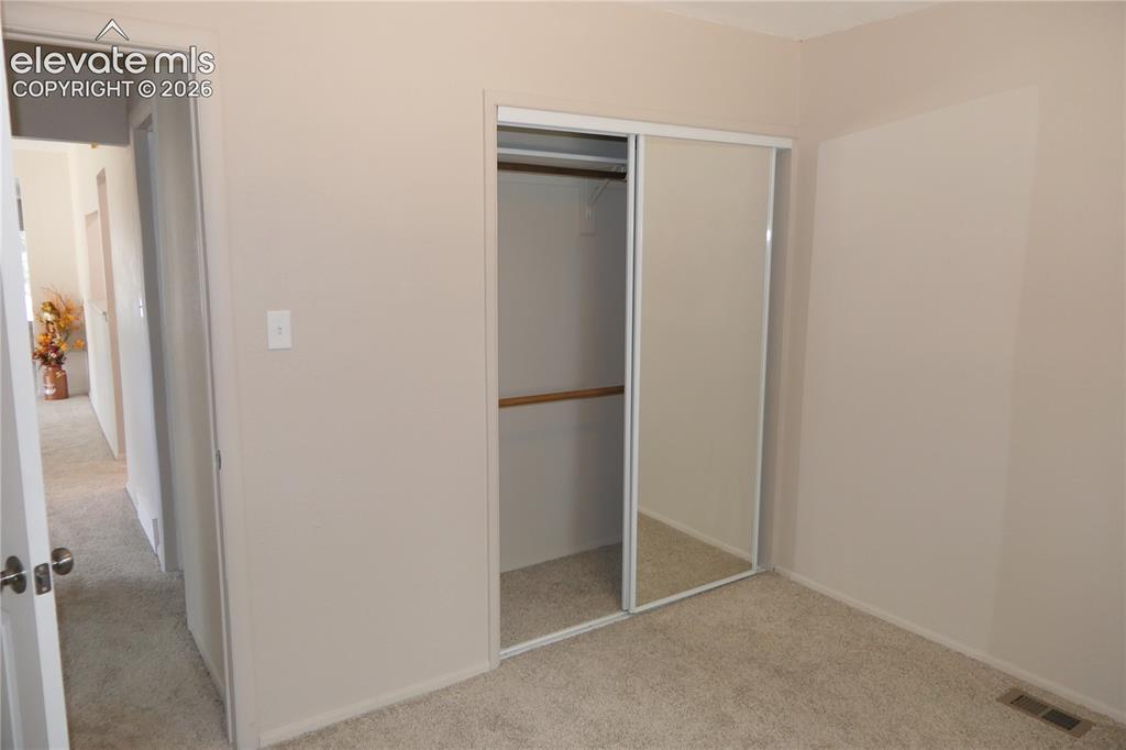 Image 26 of 39: Bedroom 1 looking towards hallway and closet