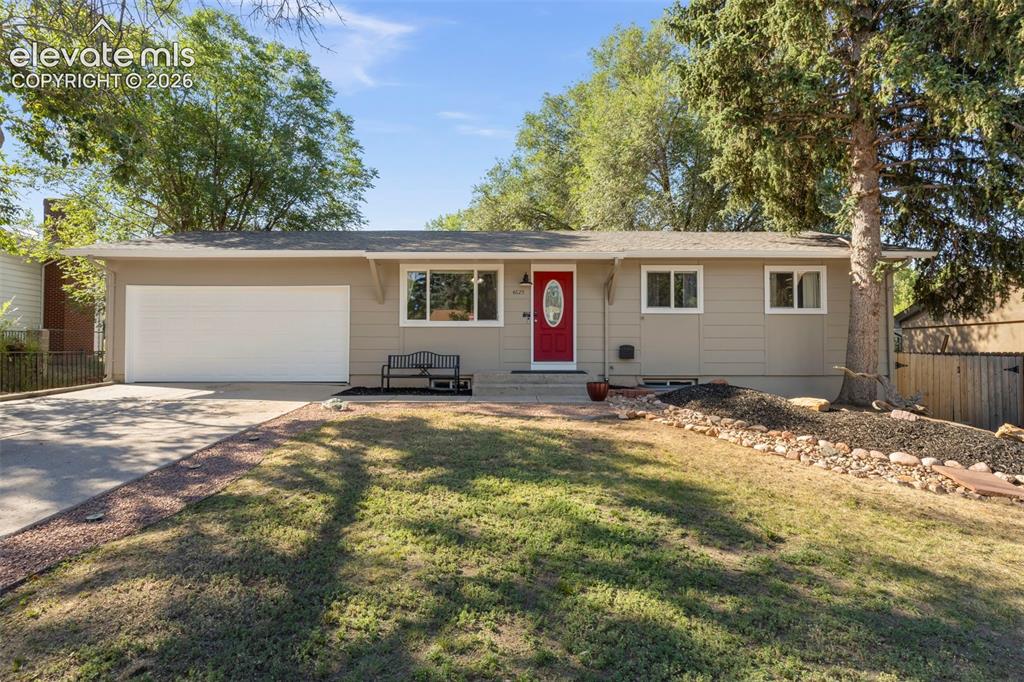 Image 1 of 30: Ranch-style residence featuring a prominent red entry door