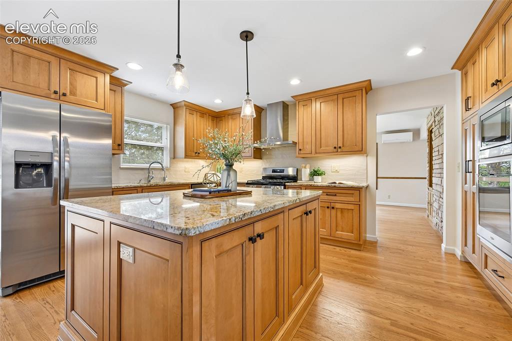 Image 11 of 49: Granite counters, textured subway tile backsplash, 2nd oven wall unit benea