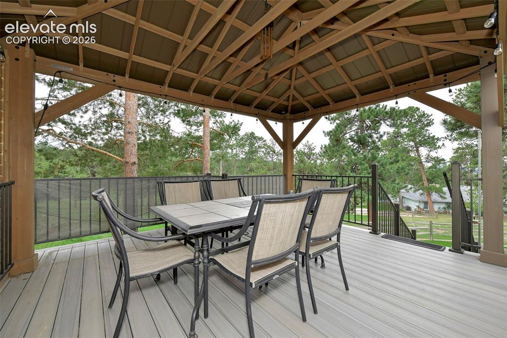 Image 16 of 49: 2nd composite deck is a gazebo retreat with stairs along terraced garden be