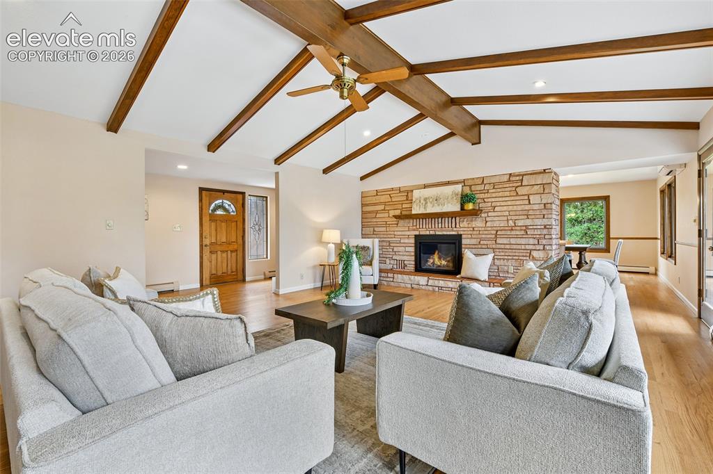 Image 5 of 49: Gorgeous wood beams on the vaulted ceiling, hardwood floors and flagstone g