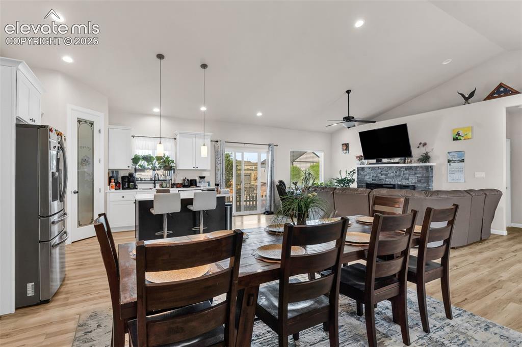 Image 13 of 49: Open-concept interior featuring wood-finish flooring, recessed lighting, an