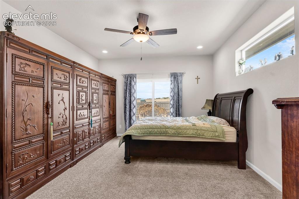Image 18 of 49: Spacious room featuring extensive built-in dark wood cabinetry with intrica
