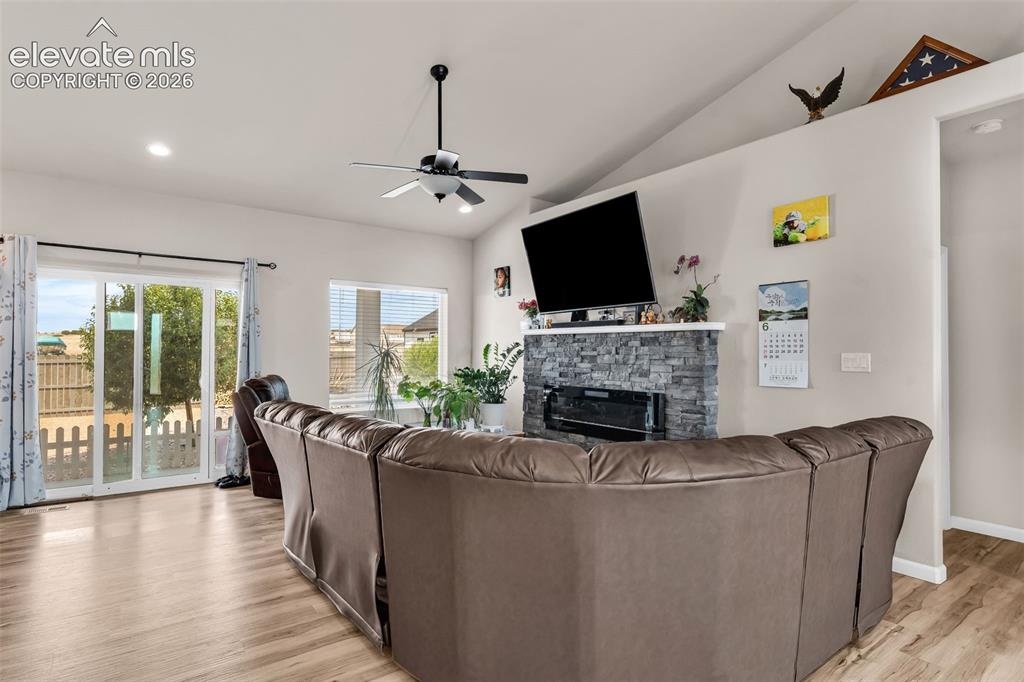 Image 8 of 49: Living area featuring vaulted ceilings, recessed lighting, and wood-finish