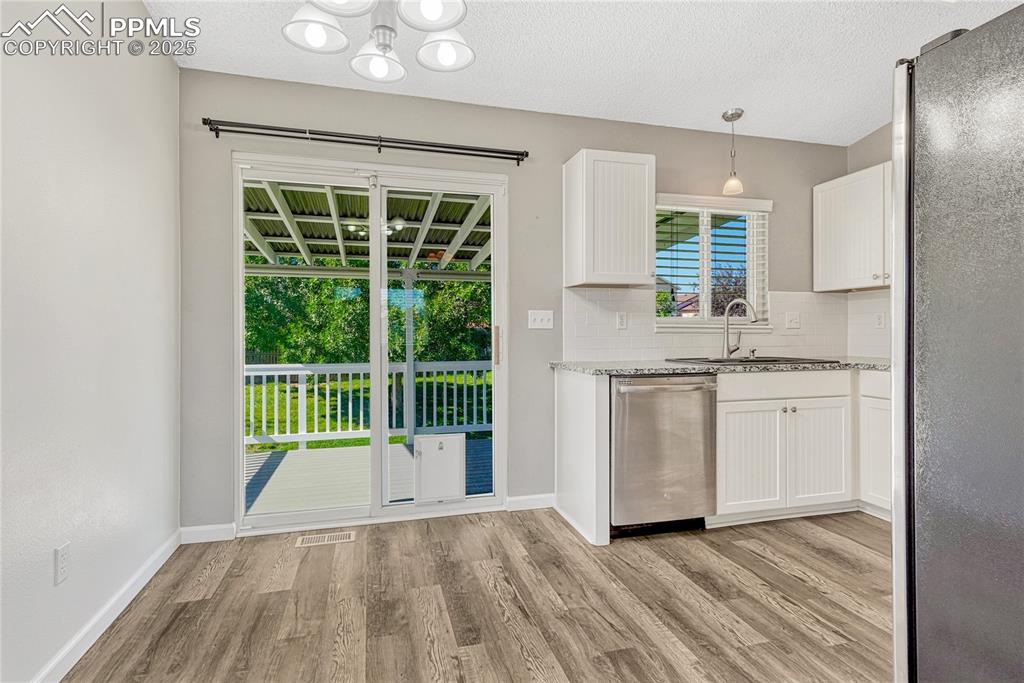 Image 11 of 50: Dining Area with Walkout to Covered Deck