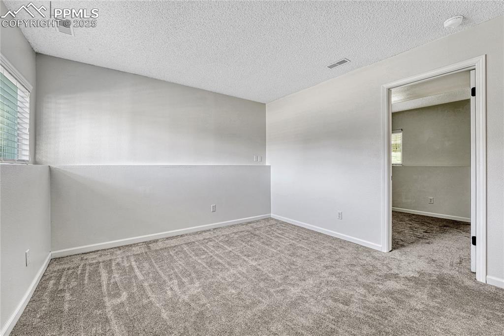 Image 33 of 50: Family Room with Access to Secondary Bedroom