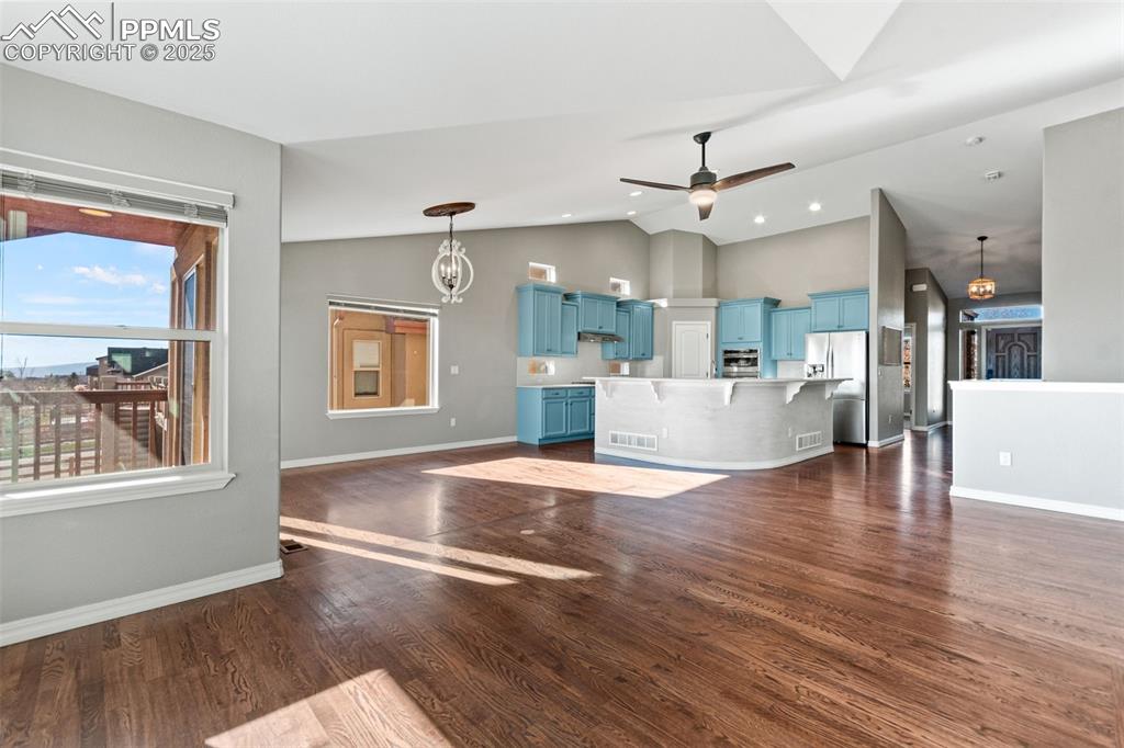 Image 13 of 45: Unfurnished living room featuring dark wood finished floors, vaulted ceilin