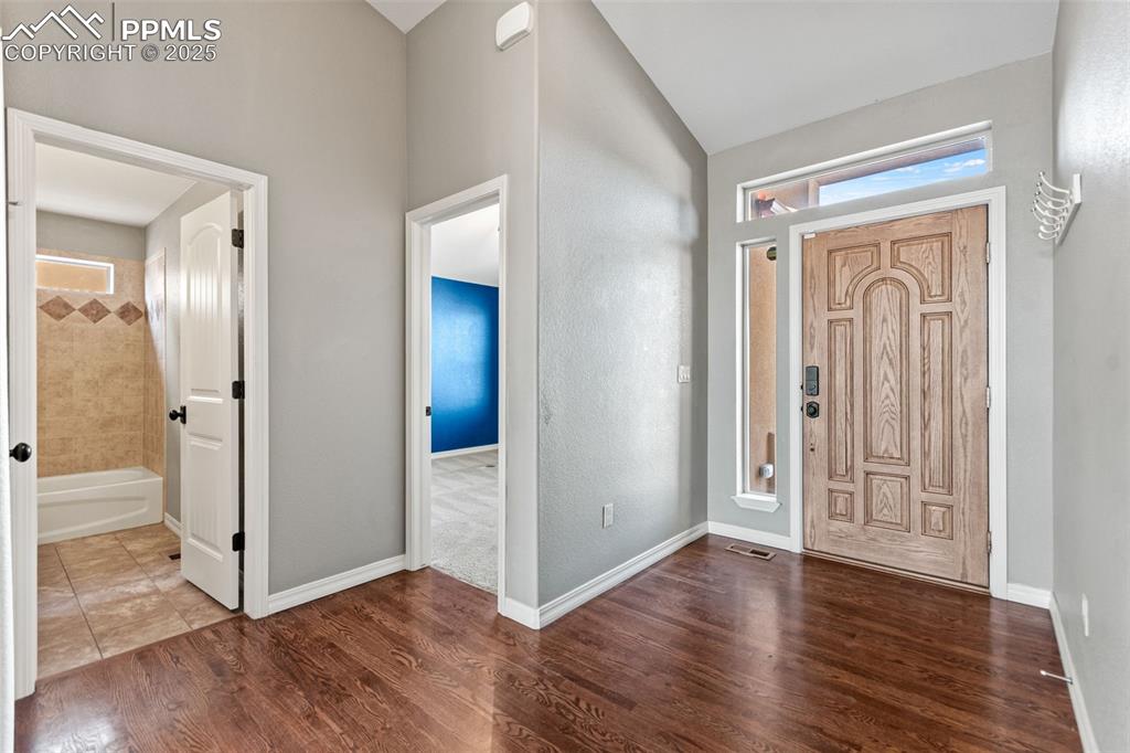 Image 19 of 45: Entryway with dark wood-type flooring and baseboards