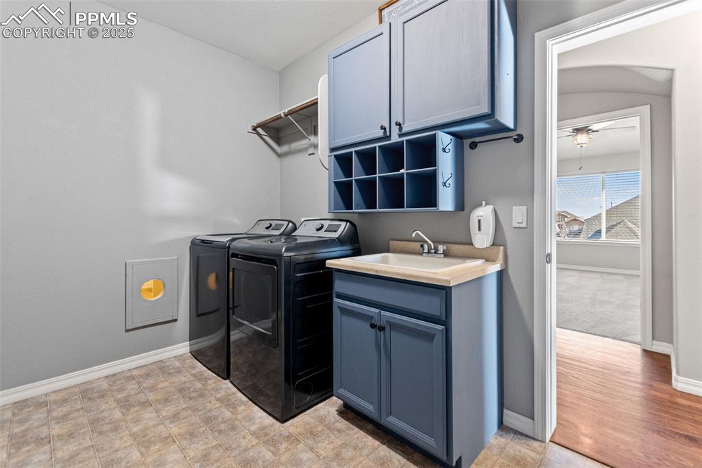 Image 29 of 45: Washroom with cabinet space and independent washer and dryer