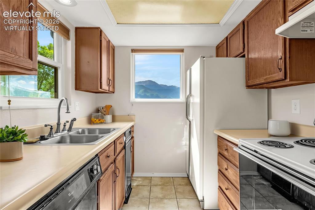 Image 7 of 33: Mountain views from the kitchen - virtually staged