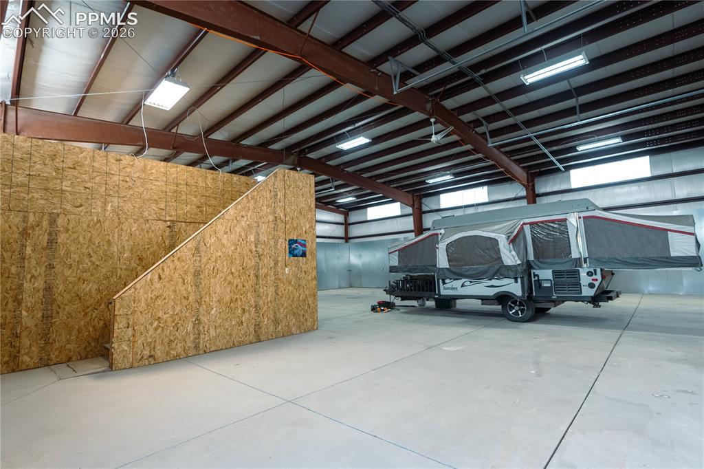 Image 26 of 42: Expansive indoor space with a concrete floor, high ceilings, exposed steel